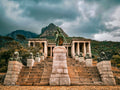 Rhodes Memorial with lion statues under stormy skies and Lion's Head behind