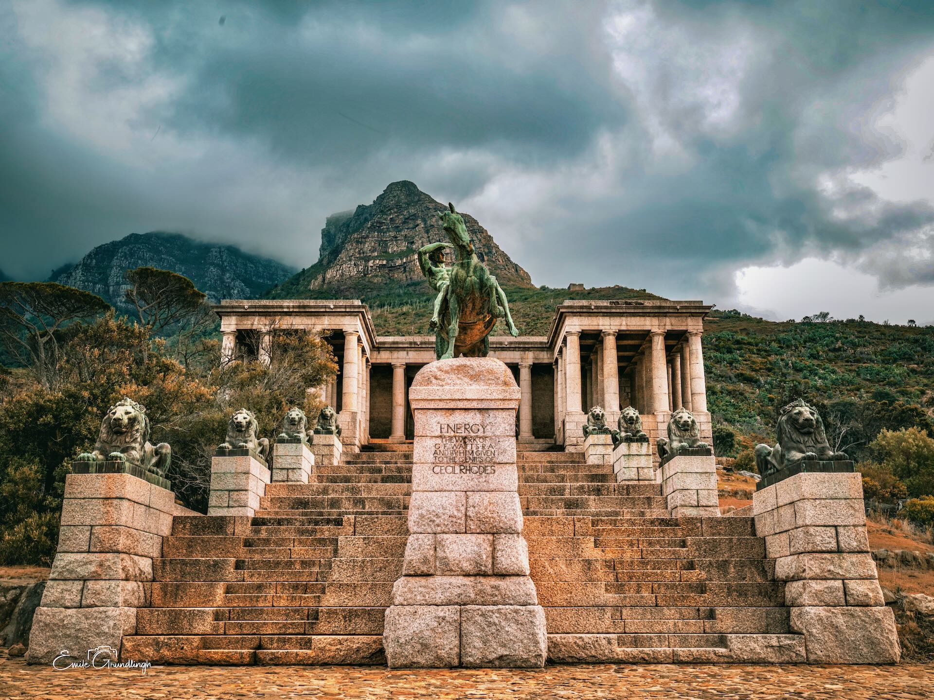 Rhodes Memorial with lion statues under stormy skies and Lion's Head behind