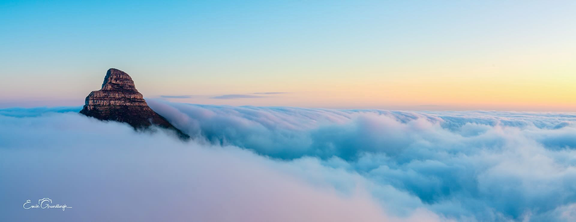 Lion's Head rising above an endless sea of clouds at sunrise aerial panorama