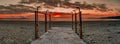 Beach showers framing a path to a fiery sunset at Clifton Beach Cape Town