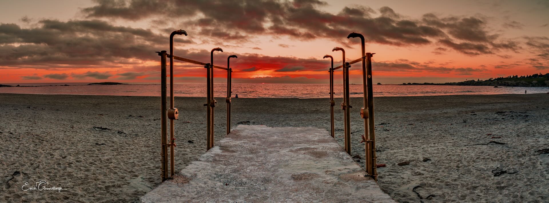 Beach showers framing a path to a fiery sunset at Clifton Beach Cape Town
