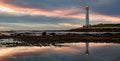 Slangkop Reflected – Slangkop Lighthouse mirrored in tidal pool at dusk, Kommetjie