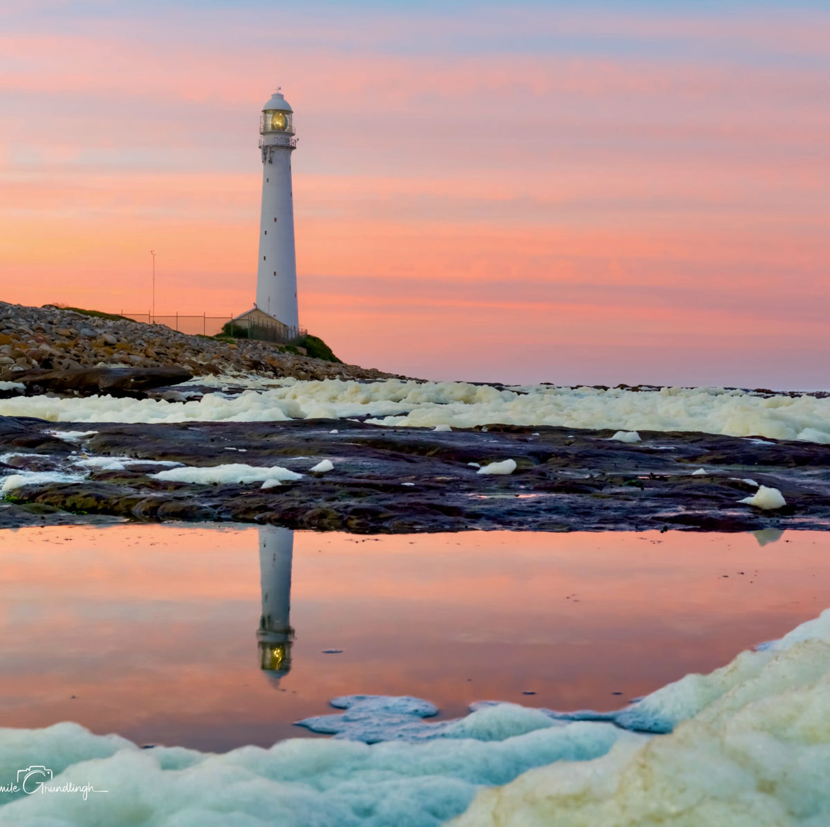 Slangkop in Blush – Slangkop Lighthouse reflected in tidal pool under peachy-pink sunset with sea foam