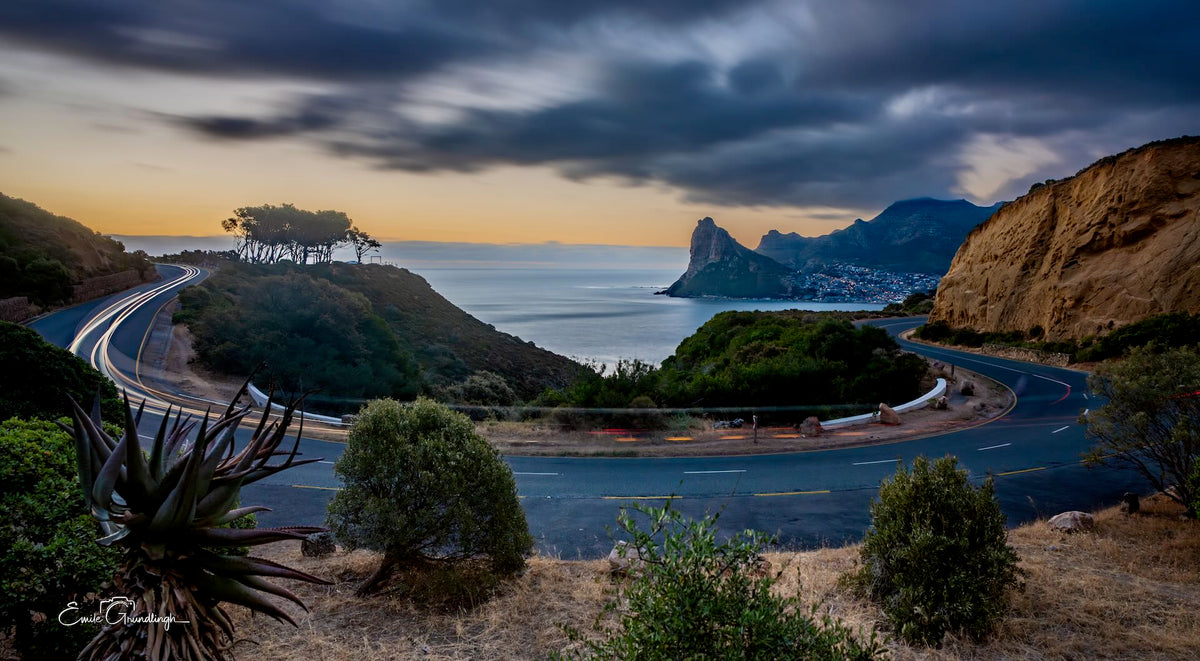 Chapman's Peak Drive at dusk with light trails and the Sentinel by Emile Grundlingh