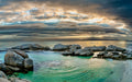 Windmill Beach panoramic view with dramatic storm clouds, granite boulders and emerald tidal pools near Boulders Beach