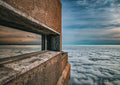 Table Mountain cable car station rising above an endless sea of clouds with window reflection