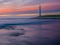 Pink Skies Over Kommetjie – Slangkop Lighthouse at sunset with pastel sky reflection