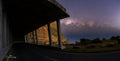 Midnight on Chapman's Peak Drive – colonnade and Milky Way with Kommetjie lights in distance