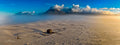 Aerial panoramic view of the SS Kakapo shipwreck on Noordhoek Beach with Table Mountain emerging through clouds in the distance