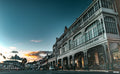 Victorian ironwork facade of Simon's Town Main Road at twilight against deep teal sky with golden sunset cloud on horizon