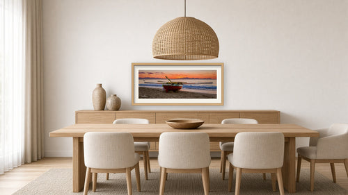 A Ragnaar at Sunset – False Bay framed in a light oak dining room above the sideboard