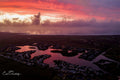 Aerial view of Lake Michelle canals reflecting crimson storm sunset by Emile Grundlingh
